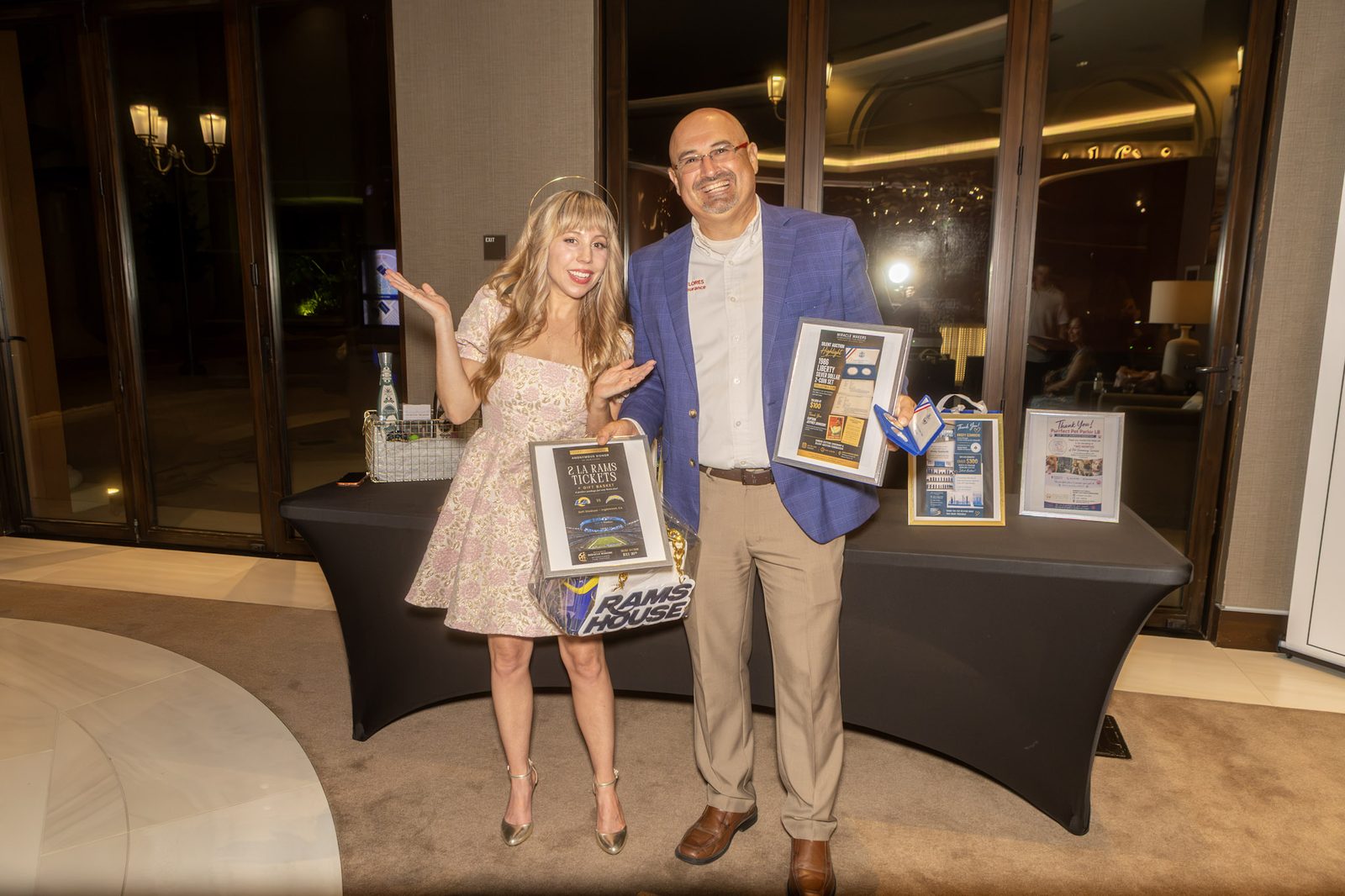 Guests holding auction items at the close of the evening